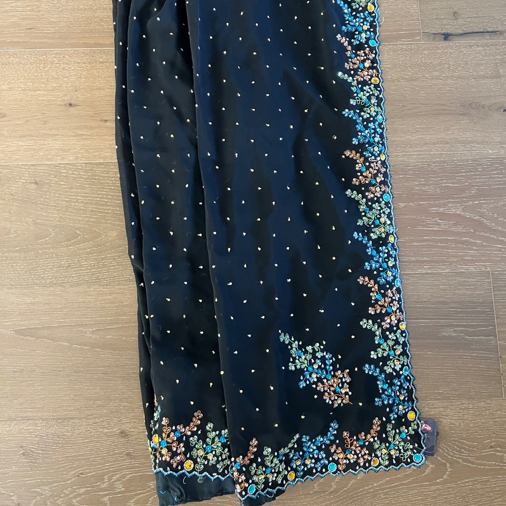 Brand new black sari with teal embroidered details.
